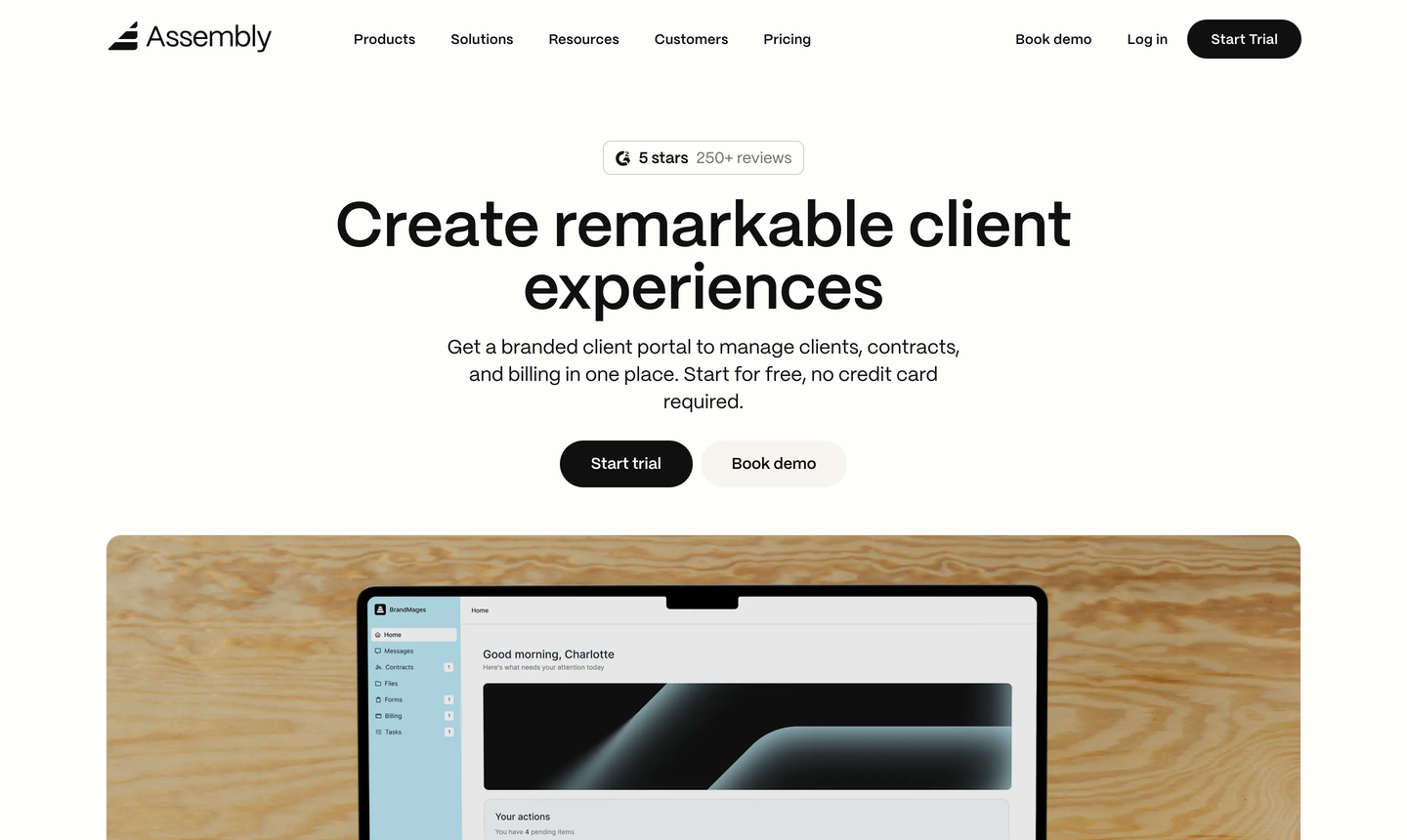 The Assembly homepage, showing its client portal dashboard on a laptop